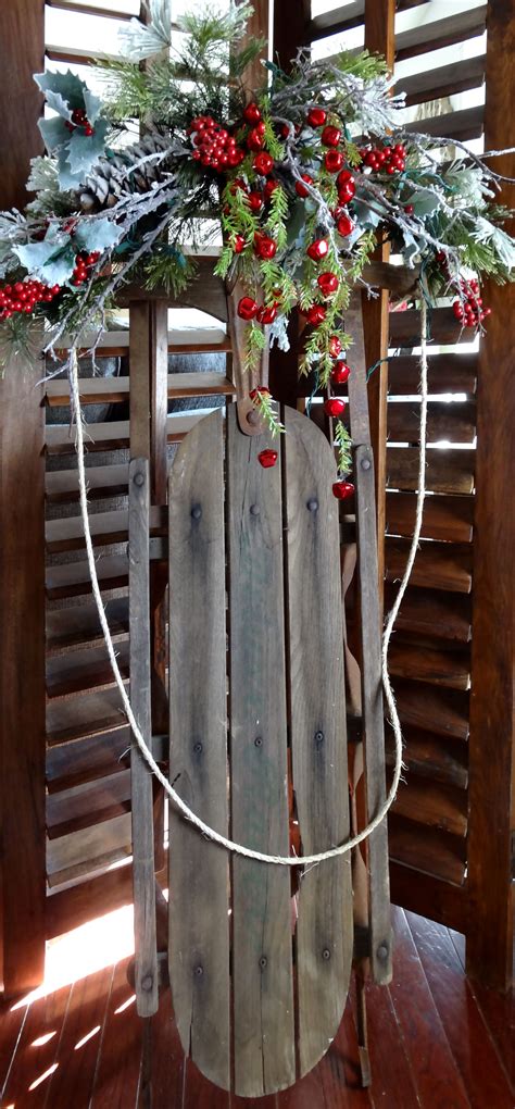 a sled decorated with holly and red berries