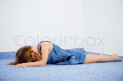 Crying child lying on the floor | Stock image | Colourbox