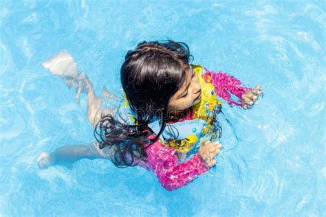 Little Girl Swimming with Floaties Stock Image - Image of playful, play ...