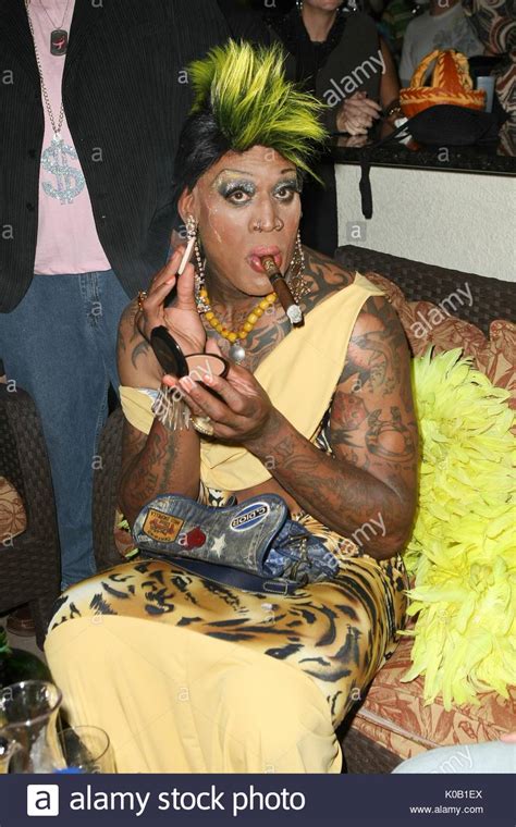 Dennis Rodman dresses in drag in a tight dress, makeup, and wig with ...