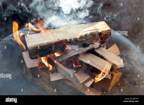 smoke development over burning logs Stock Photo - Alamy