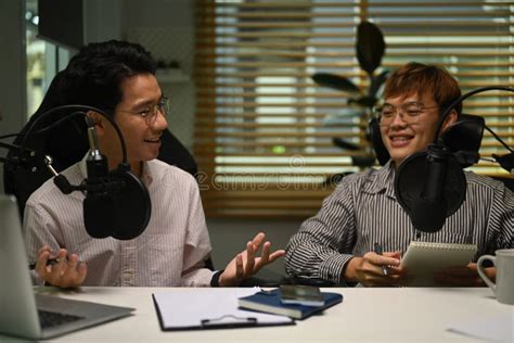 Happy Male Radio Hosts Using Condenser Microphone, Recording Voice Over Radio Interview Guest ...