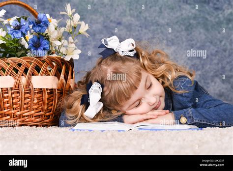 little girl lying on book Stock Photo - Alamy