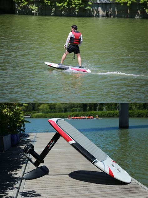 a man riding a surfboard on top of a body of water next to a paddle board