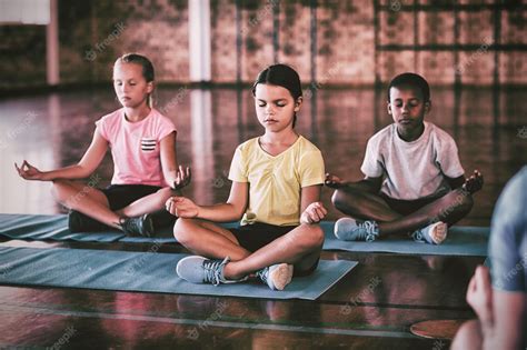 Premium Photo | School kids meditating during yoga class