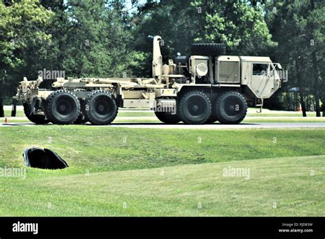 Soldiers operate an M1120 Heavy Expanded Mobility Tactical Truck (Load-Handling System) on the ...