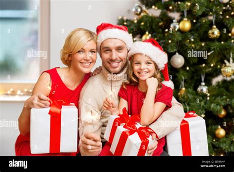 happy family with christmas gifts and sparklers Stock Photo - Alamy