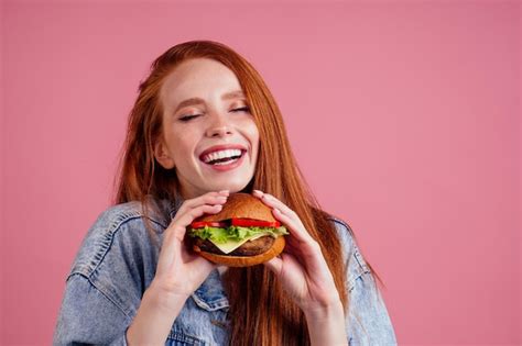 Premium Photo | Pretty long redhead ginger girl eyes closed from pleasure eating fries chicken ...
