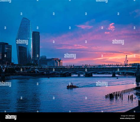 A London skyline by night background with a bridge and One Blackfriars ...