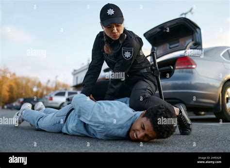 Police officer arresting suspicious young car driver Stock Photo - Alamy