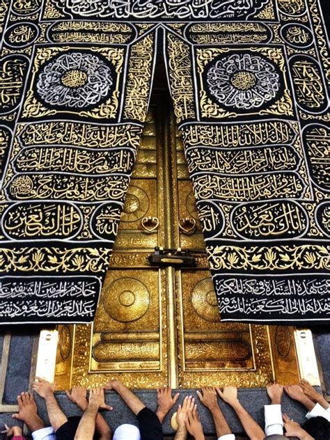 many people are standing in front of an ornate gold door with arabic ...