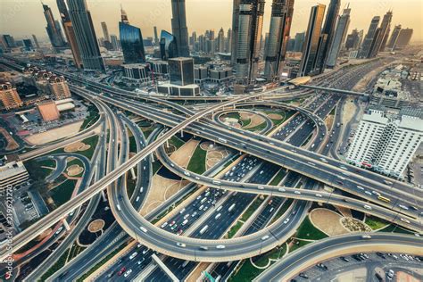 Aerial view of a big highway intersection in Dubai, UAE, at sunset ...