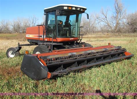 Hesston 8450 swather in Tampa, KS | Item E8173 sold | Purple Wave