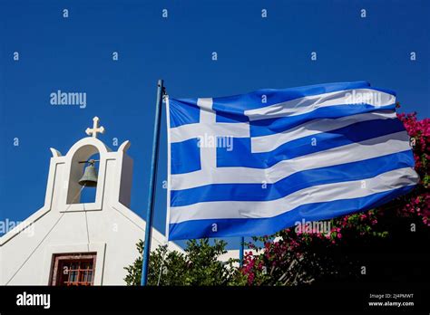 Greek flag waving against the blue sky and Greek architecture Stock Photo - Alamy