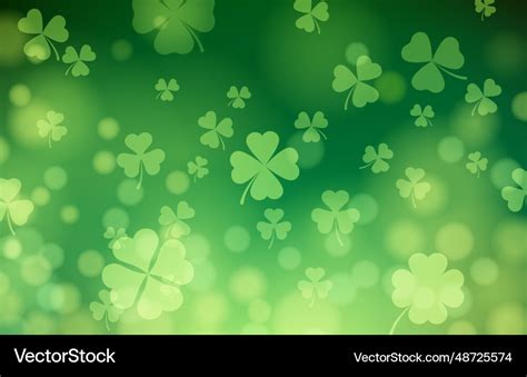 Bokeh background with falling clover leaves Vector Image