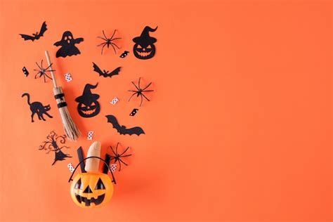 Premium Photo | Halloween crafts on orange background with copy space.