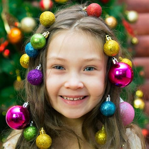 Premium Photo | Girl with christmas decorations on her head.