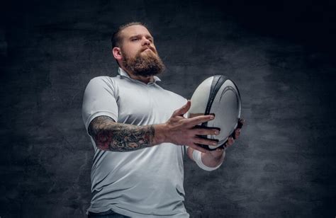 Free Photo | Portrait of bearded rugby player with tattoos on his arms