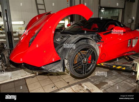 Novosibirsk, Russia - 07.25.2019: Red sports car Marussia B1 raised on a lift in a car repair ...