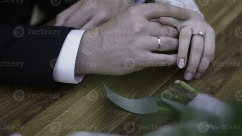 Wedding couple holding hands. Young married couple holding hands ...