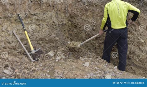 A Man Digging a Hole with a Shovel, Removing the Soil with the Shovel Stock Photo - Image of ...