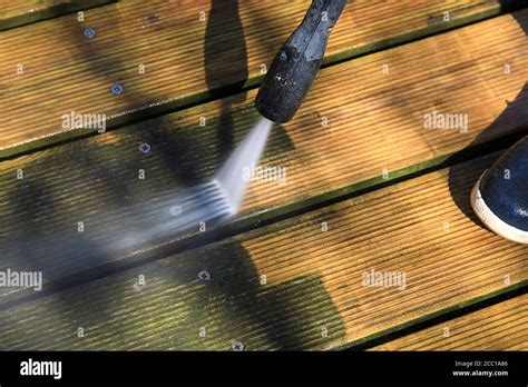 Use of a high pressure cleaner. Cleaning a wooden deck Stock Photo - Alamy