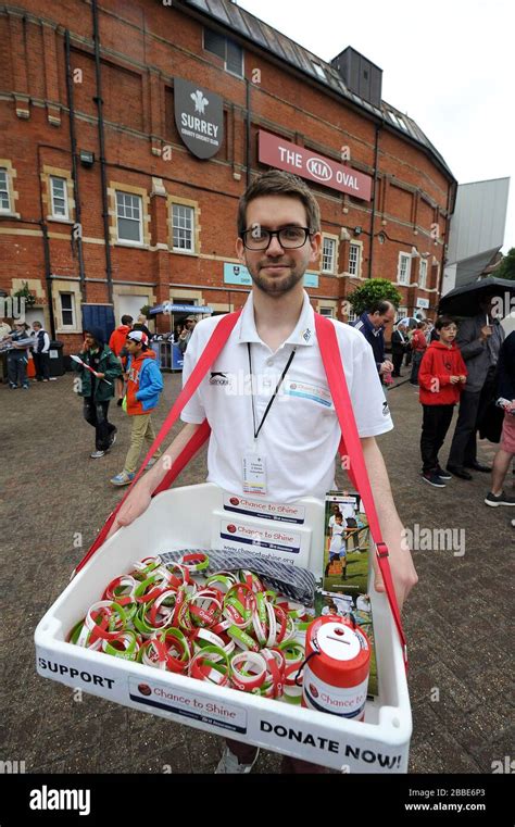 Staff selling Chance to Shine charity wristbands Stock Photo - Alamy