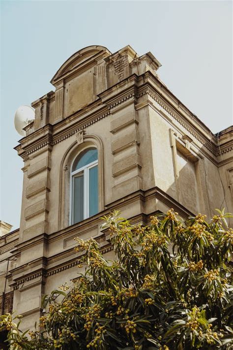 Brown Brick Building With an Arched Window · Free Stock Photo