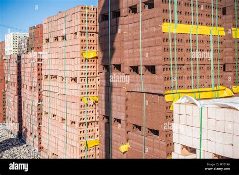 Piles of bricks for sale at brick yard Stock Photo - Alamy