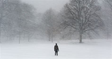 Snowstorm Sends Heavy Snow Across East Coast - A person goes into ...