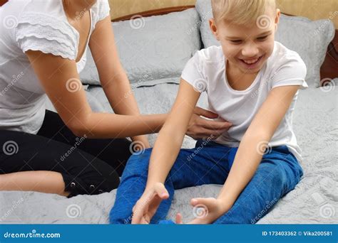 Tickle the Child. Happy Mother and Son on the Bed. Funny Motherhood. Stock Photo - Image of ...