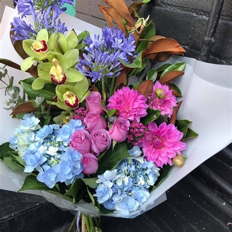 a bouquet of colorful flowers sitting on top of a white piece of paper ...