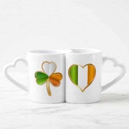 two coffee mugs with irish flags in the shape of heart and shamrock leaves on them