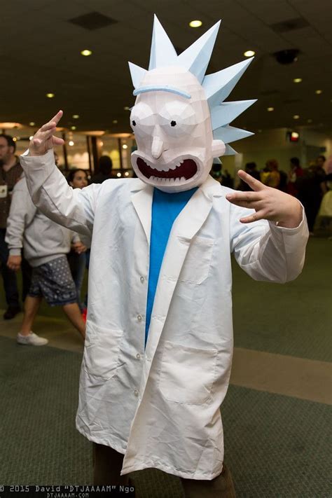 a man in a white lab coat with his hands up