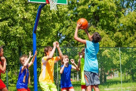 Teenagers playing basketball game together — Stock Photo © serrnovik #88608500