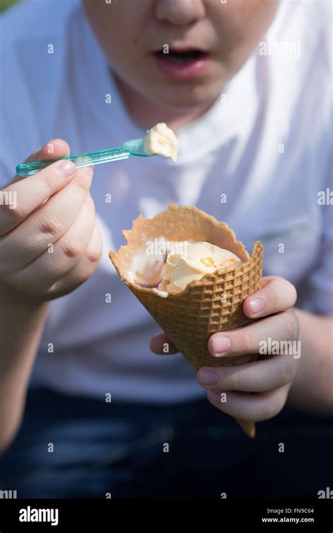 Boy eating ice-cream cone Stock Photo - Alamy