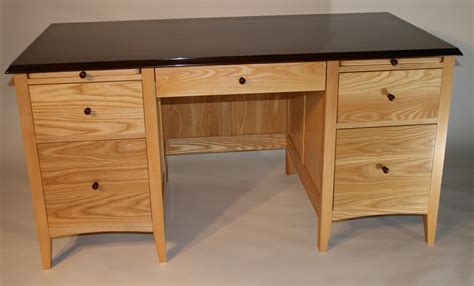 Double pedestal desk in ash, with client-provided top, 30" x 60". All drawers are dovetailed ...