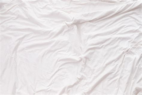 Fundo de textura de folha de cama branca. | Foto Premium