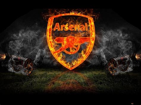 Arsenal football club logo dark logo on the stadium grass among the fog ...