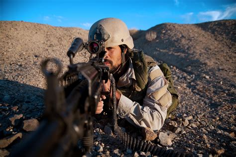 US Navy SEAL David Goggins aiming through his Aimpoint red dot optic ...