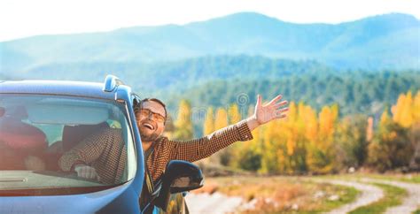 Handsome Young Man Driving a Car while Travel in Beautiful Mountains ...