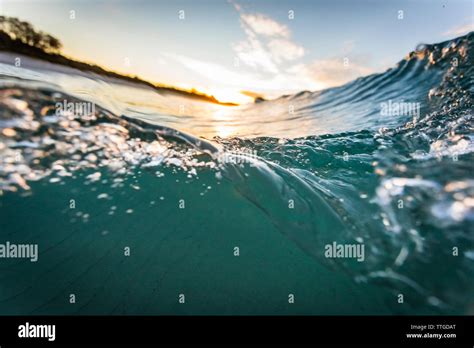 Wave at sunrise Stock Photo - Alamy