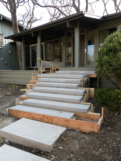 Floating concrete steps sitting in forms are sitting upon a 2' footer that supports the steps ...