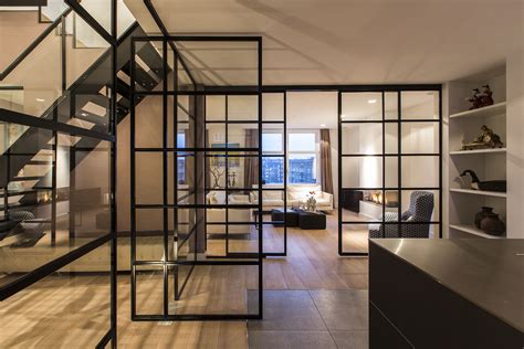 Black Framed Glass Doors Are A Prominent Feature Of This Apartment's ...