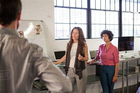 Business people talking in office - Stock Photo - Dissolve