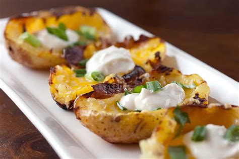 Cheesy yukon gold potato skins topped with a dollop of spicy sour cream. Perfect for your ...