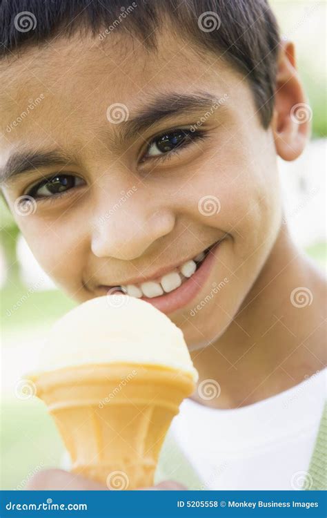 Young Boy Eating Ice Cream Cone Stock Photo - Image of dessert, camera: 5205558