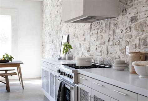 A magnificent stone wall in the kitchen, olive trees in pots, wooden beams on the ceiling – you ...