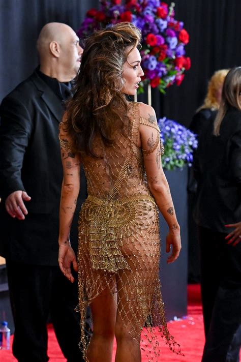 Miley Cyrus Wears See-Through Gold Dress at the 2024 Grammys