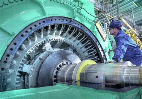 Engineer inspecting generator in nuclear power station during outage - Stock Photo - Dissolve